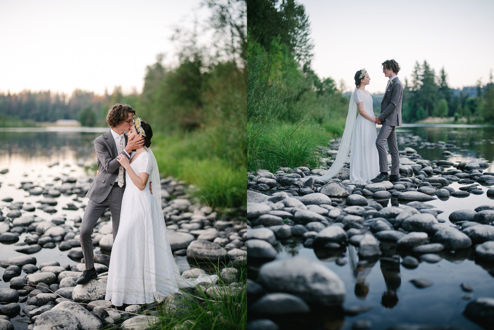  Wedding couple face each other on river bank pebbles with reflection of blue water 