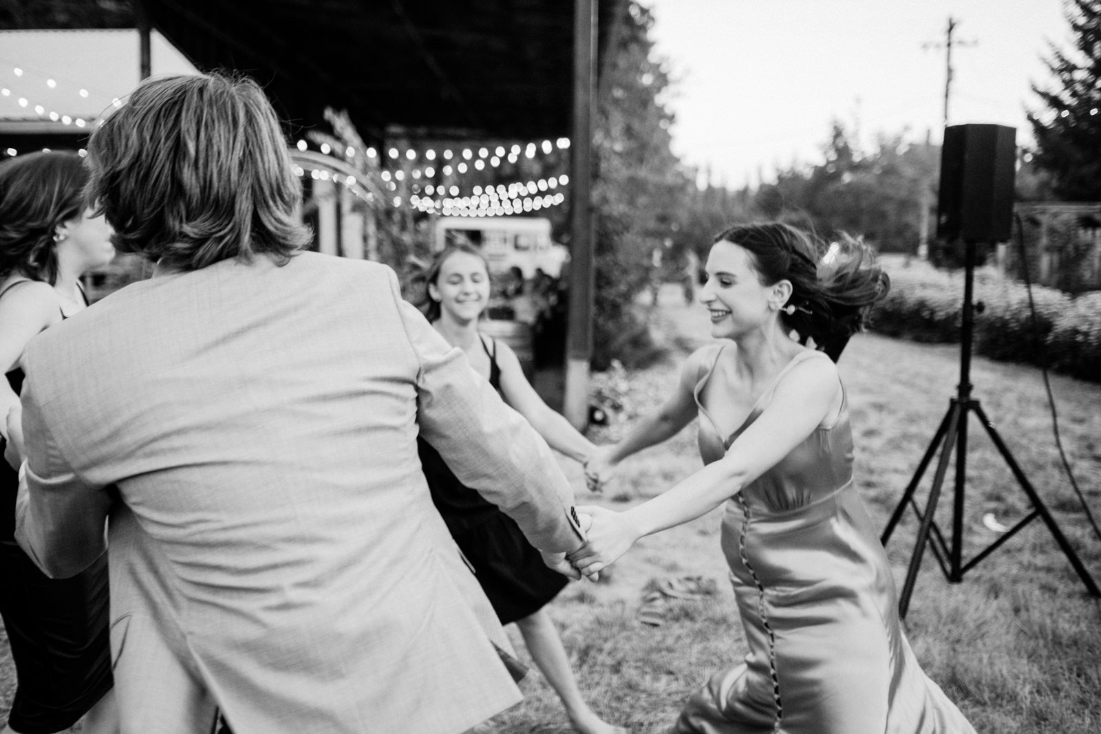 Bridesmaid twirls with guests in black and white candid moment 