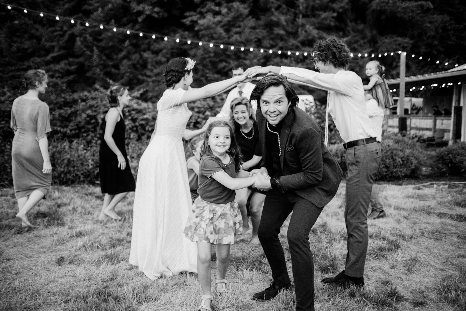  Wedding guests dance under arms in English line dancing 
