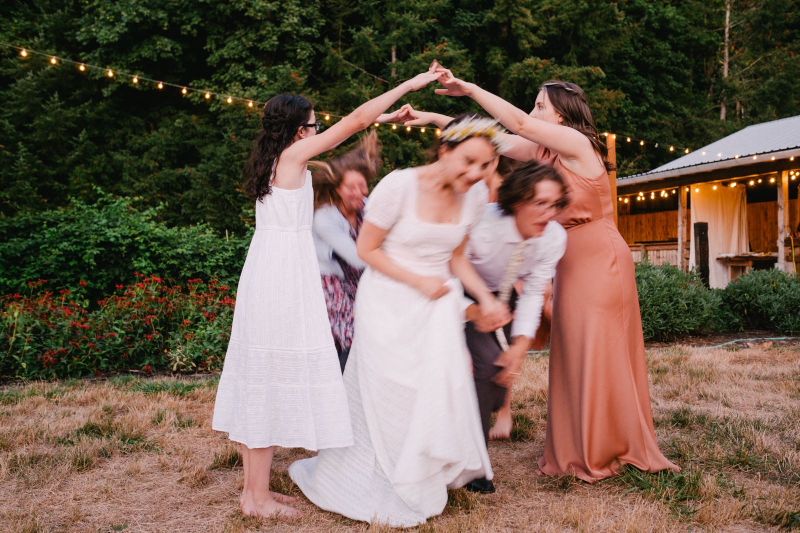  Bride and groom pass through arms in English line dancing 