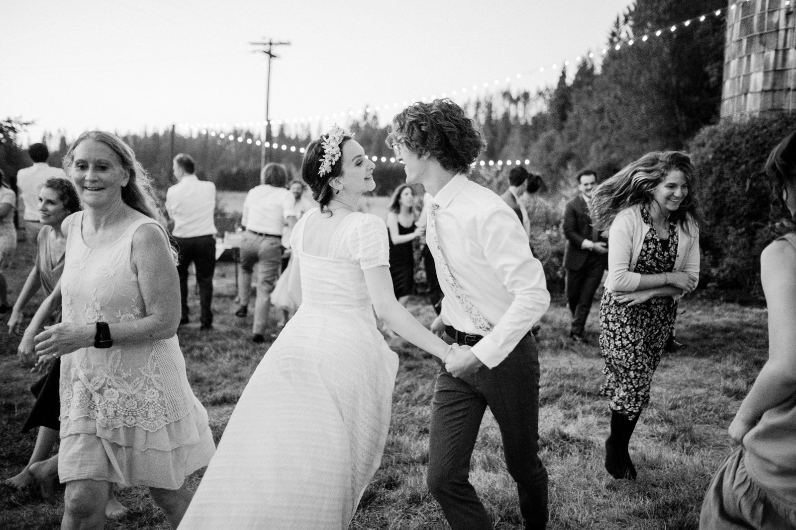  Bride and groom twirl and dance in black and white candid photo 
