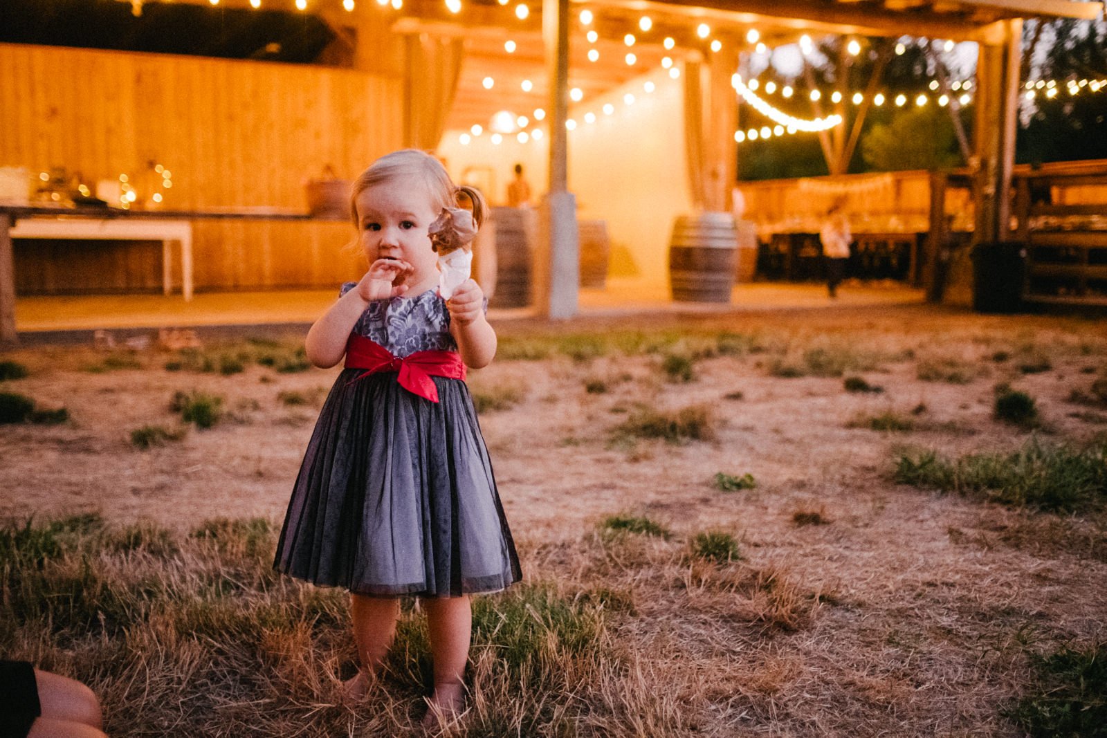  Little girl holds large chocolate ice cream in twinkle lights 