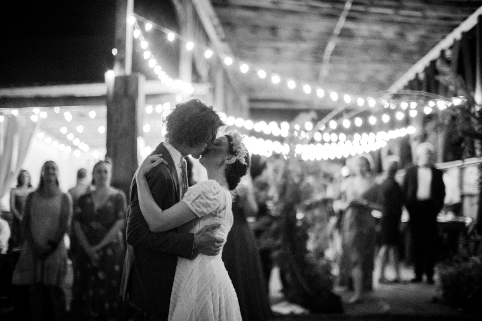  Bride and groom kiss in classic black and white photo in evening 