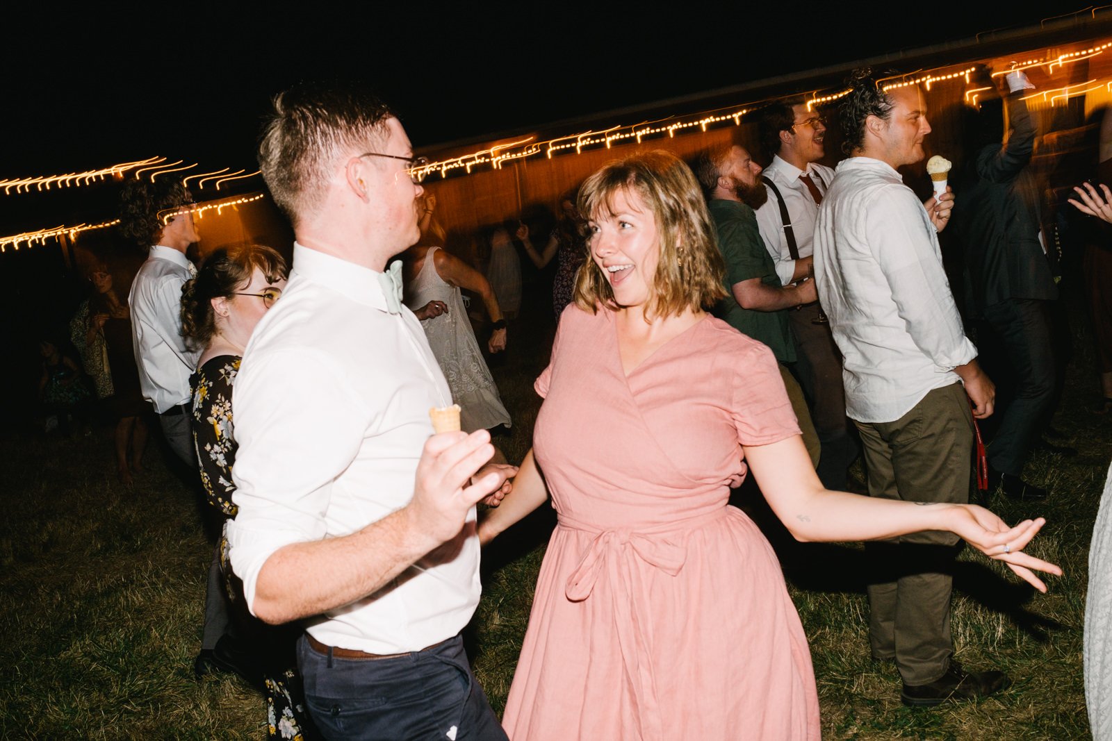  Couple dances together in pink dress at reception party 