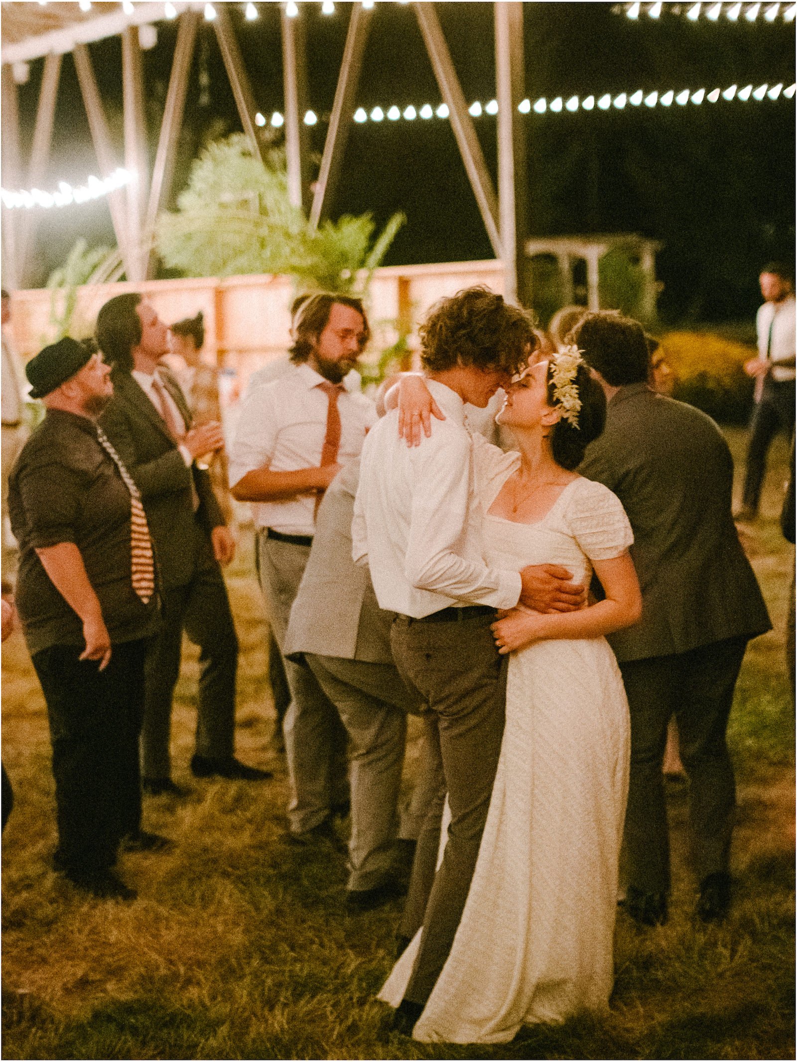  Couple dances together in low light wedding reception 