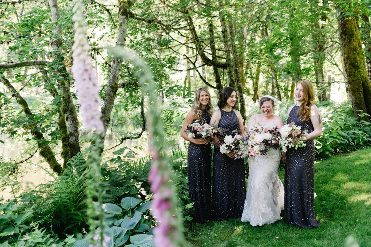  Bride giggling together in bridesmaids portrait in hollyhock 