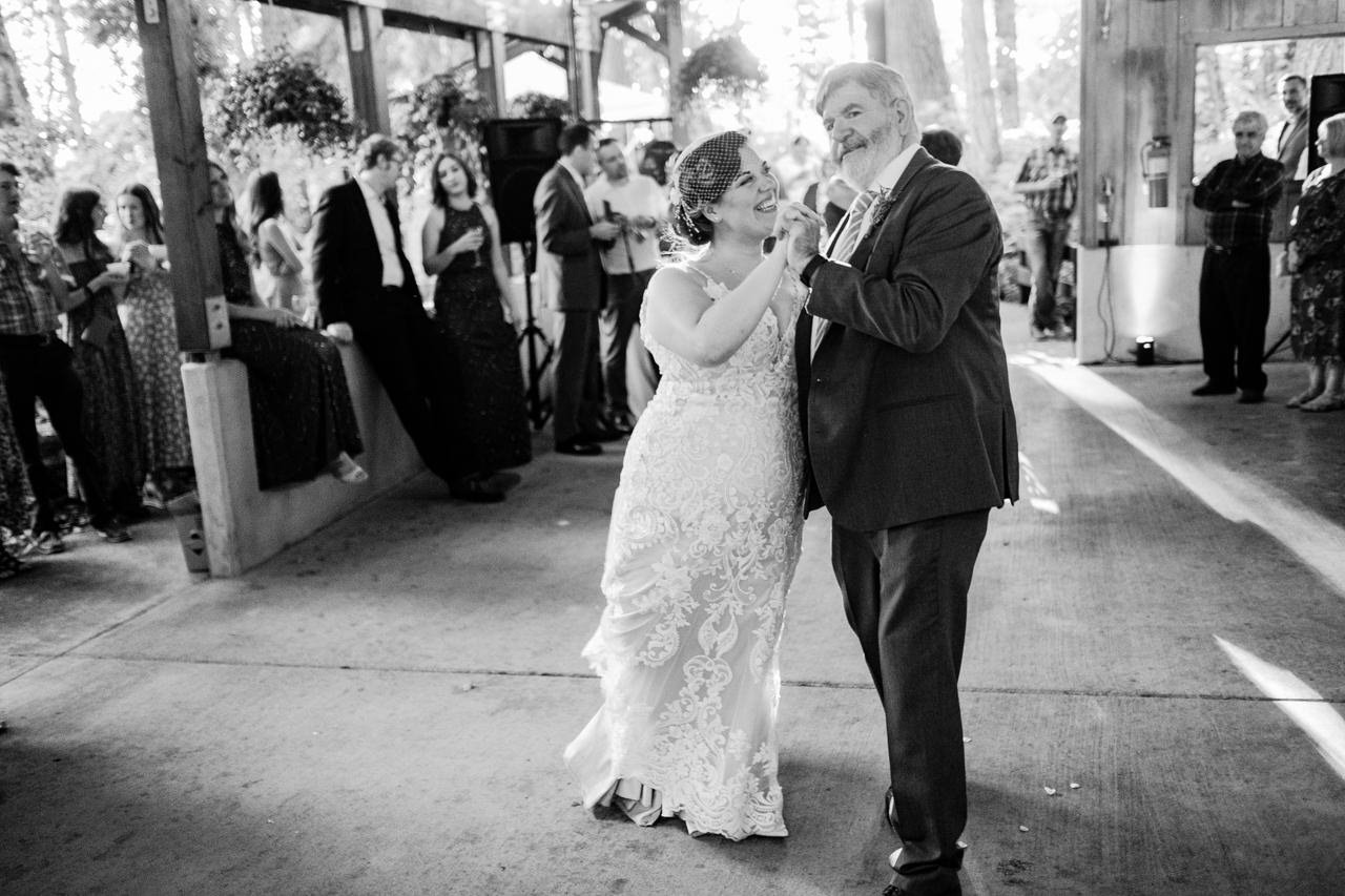  Bride laughs at father during dance 