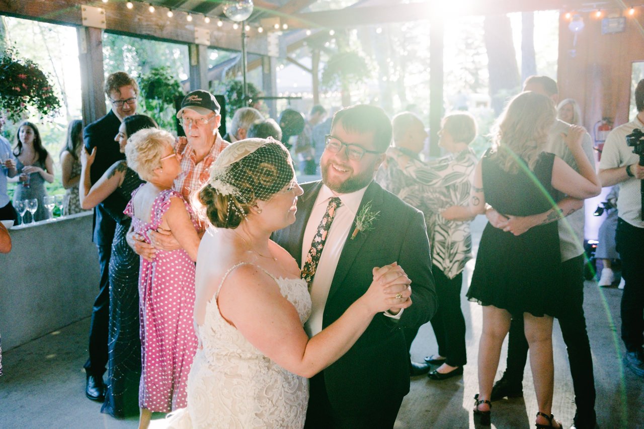  Bride and groom do anniversary dance in flared sunlight 