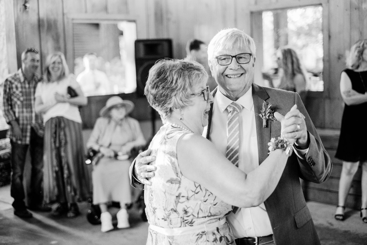 Parents of groom dance together in black and white moment 