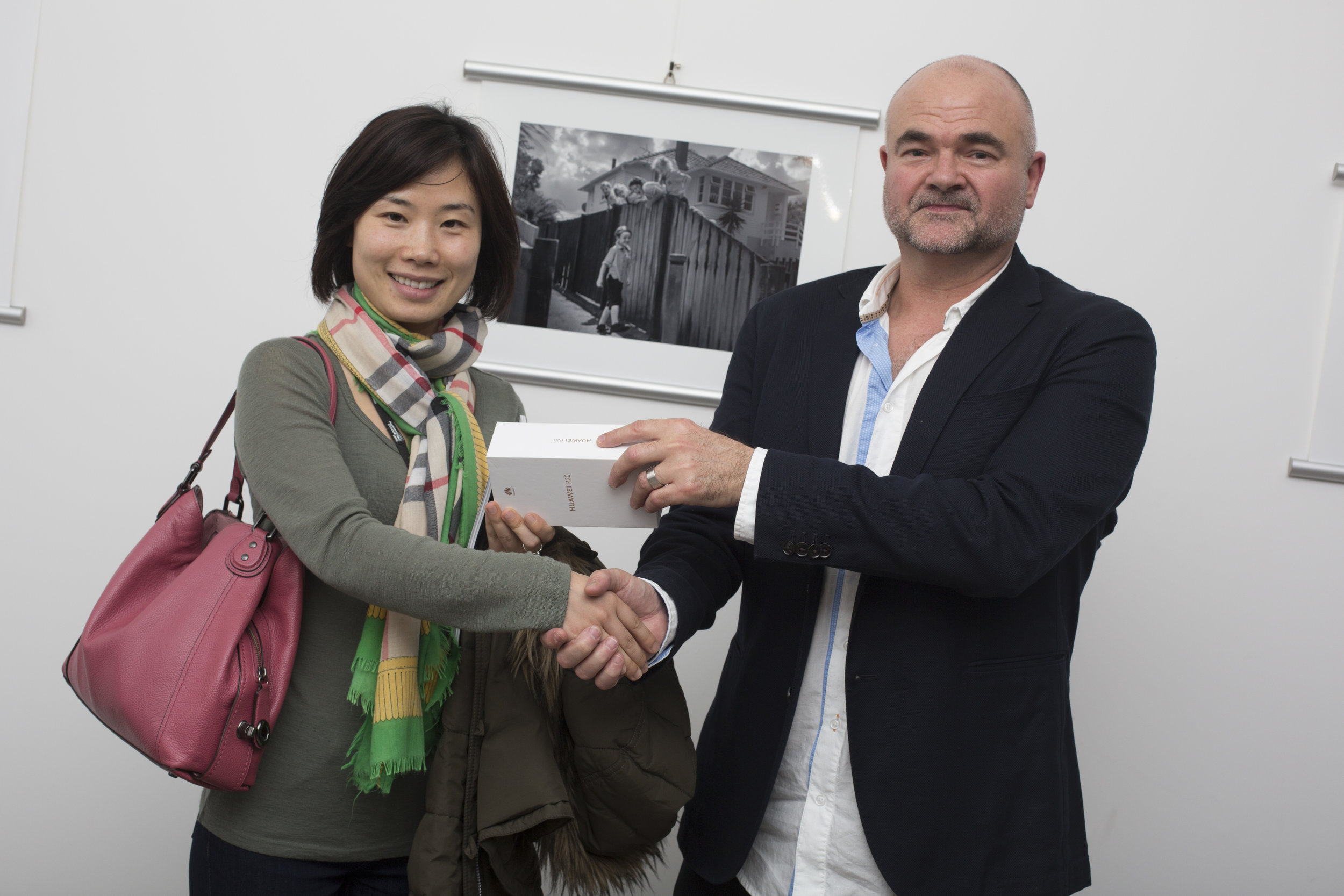  Daughter of second-placing Smartphone photographer, Bin Bai, accepts the Huawei P20 on his behalf 