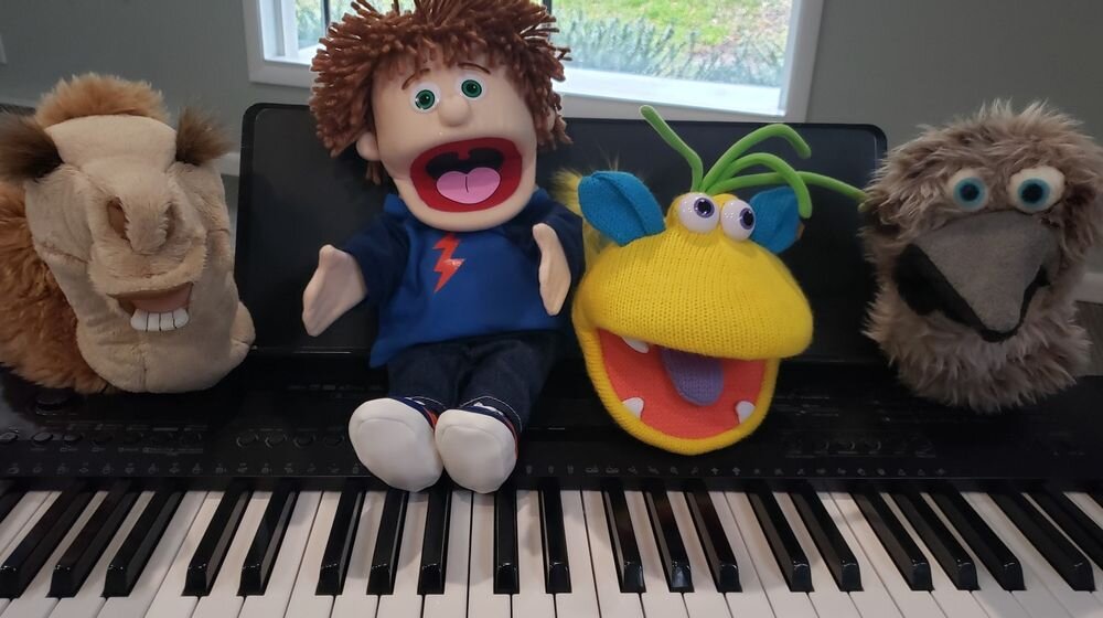 bunch of puppets on piano.jpg