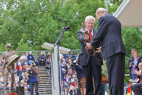 Ian Kerr (Maygar) presents RSL Sub Branch President, Phil Munt with Lt. Col. Leslie Maygars ceremonial sword.