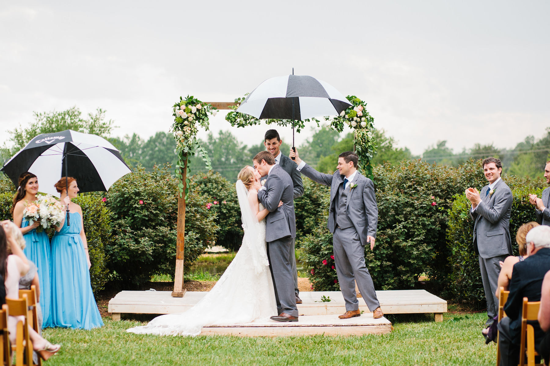 Bride and Groom First Kiss in the Rain