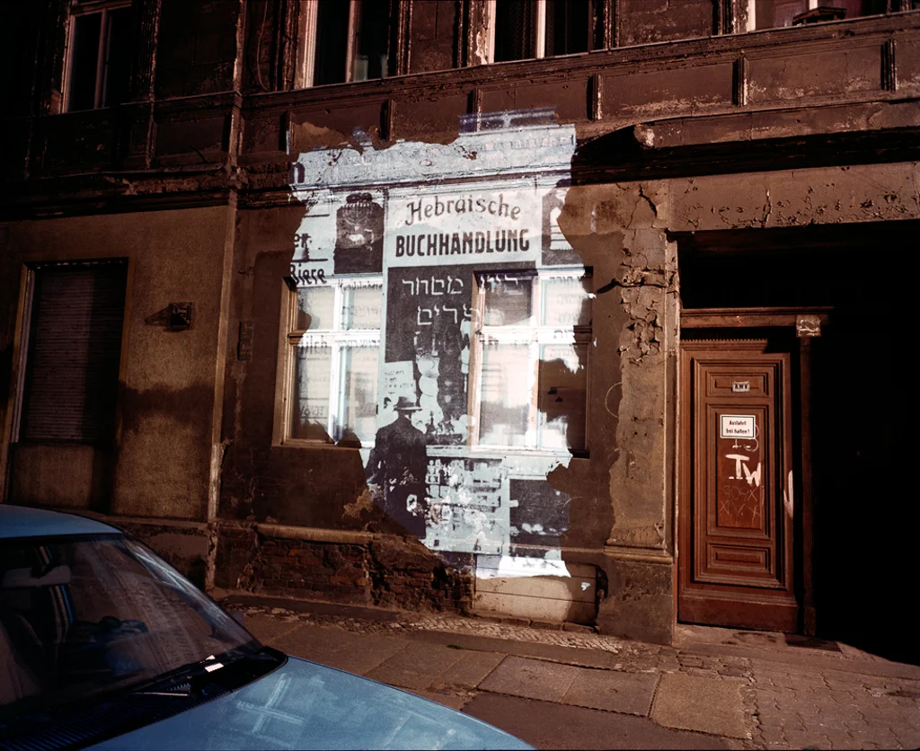 © Shimon Attie Almstadtstrasse 43: Slide projection of former Hebrew bookstore, 1930 , Berlin, 1992, on-location installation at 1:1 architecture scale and 33"X40" chromogenic photograph, from the project The Writing on the Wall , courtesy of Jack Shainman Gallery, NY