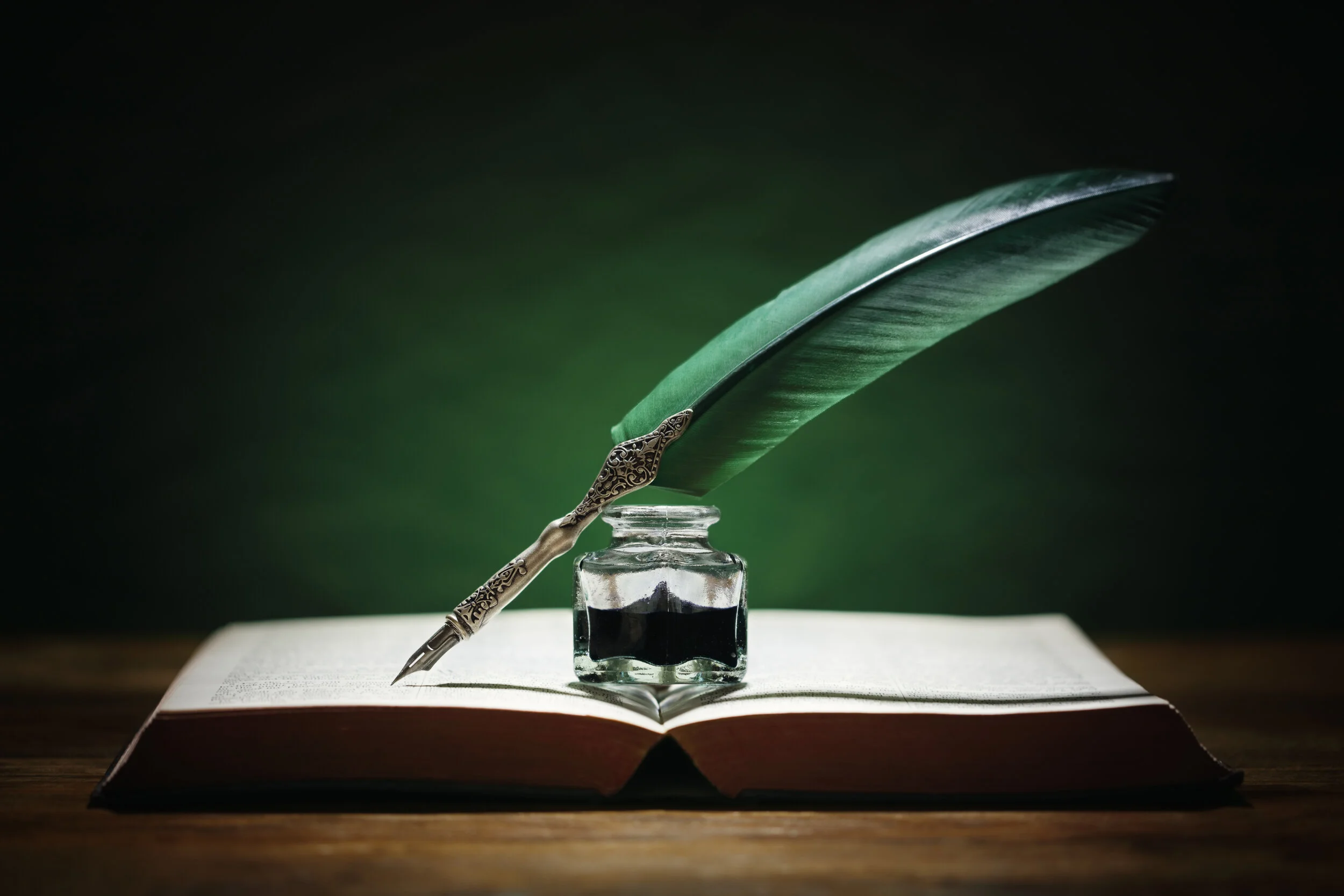 quill-pen-and-inkwell-on-old-book-U5L6MKP.jpg