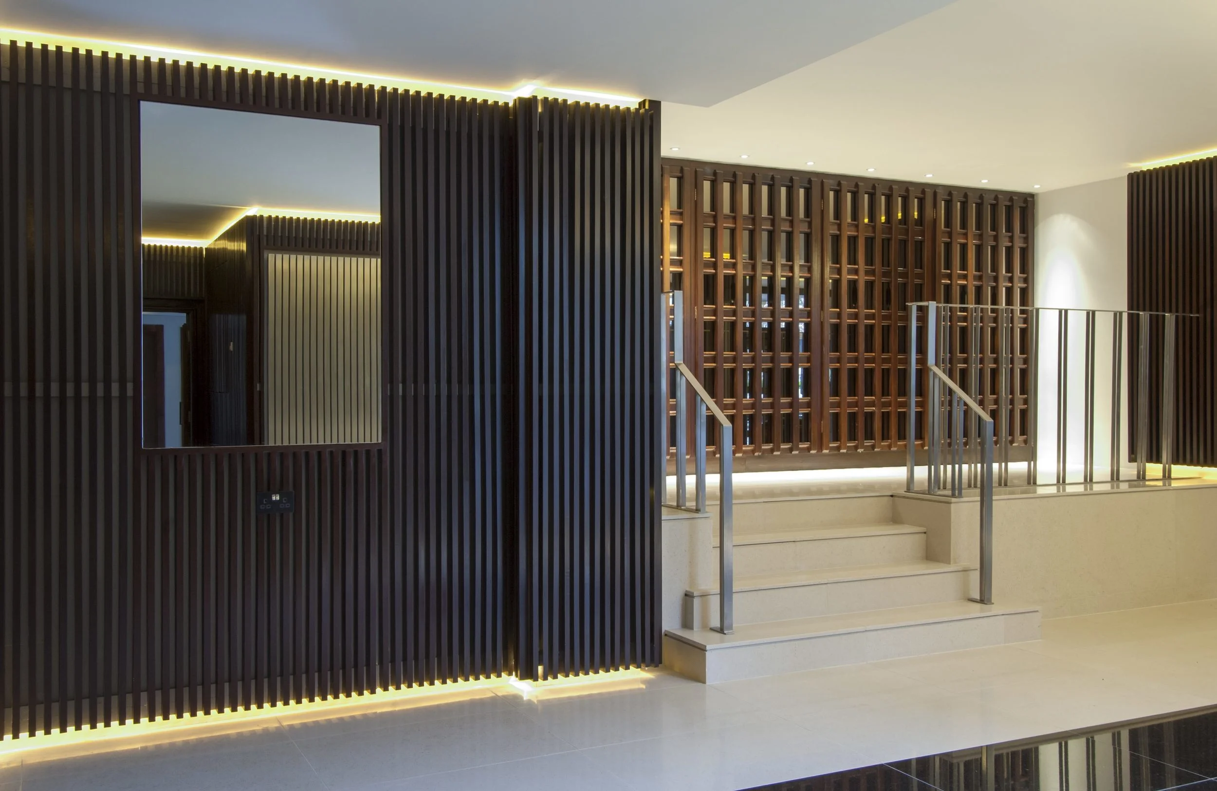 The main lobby area was divided into three areas - main reception desk with corresponding floor and lifted ceiling. The subsequent area were leading to the lifts and the flats. The floors wee cladded in limestone and black granite inserts. 
