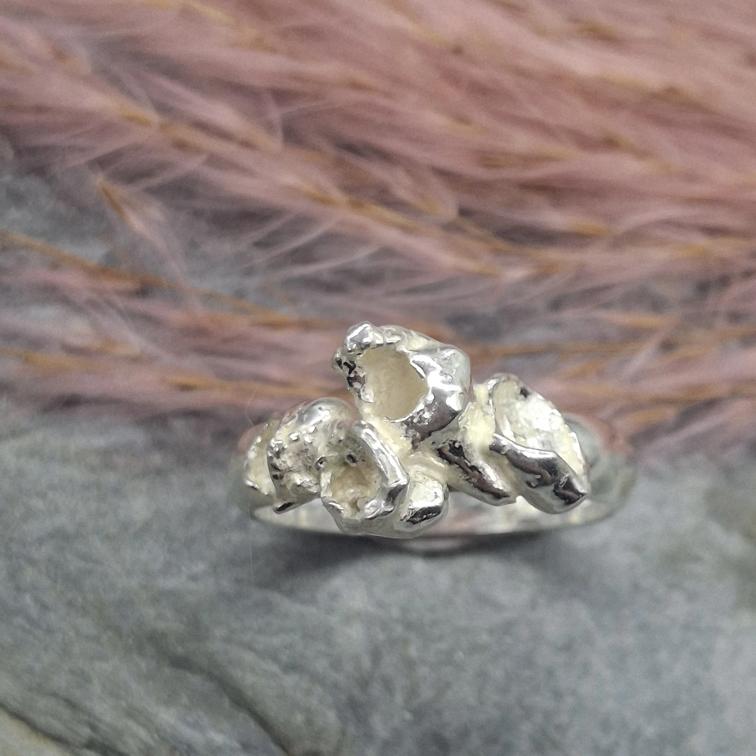 Handmade sterling silver Fallen Blossom ring with organic water-cast petal textures, inspired by fallen cherry blossom, with no gemstone.