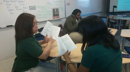 Briana Thomas and Trayona Lawrence, discussing the symbolism of the novel The Great Gatsby. 