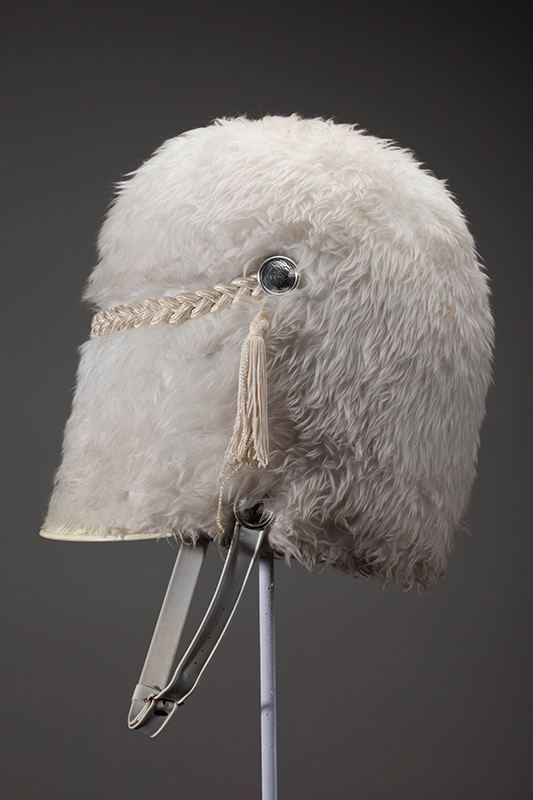 One of the hats featured in the Hats Off to Dr. Seuss Exhibition. Made by Stanbury Co., Kansas City, of leather, plastic, metal and white fake fur. A gift from San Diego State University in 1986. Ted was chosen honorary chairman of the Holiday Bowl football game between the Iowa Hawkeyes and the San Diego State Aztecs.