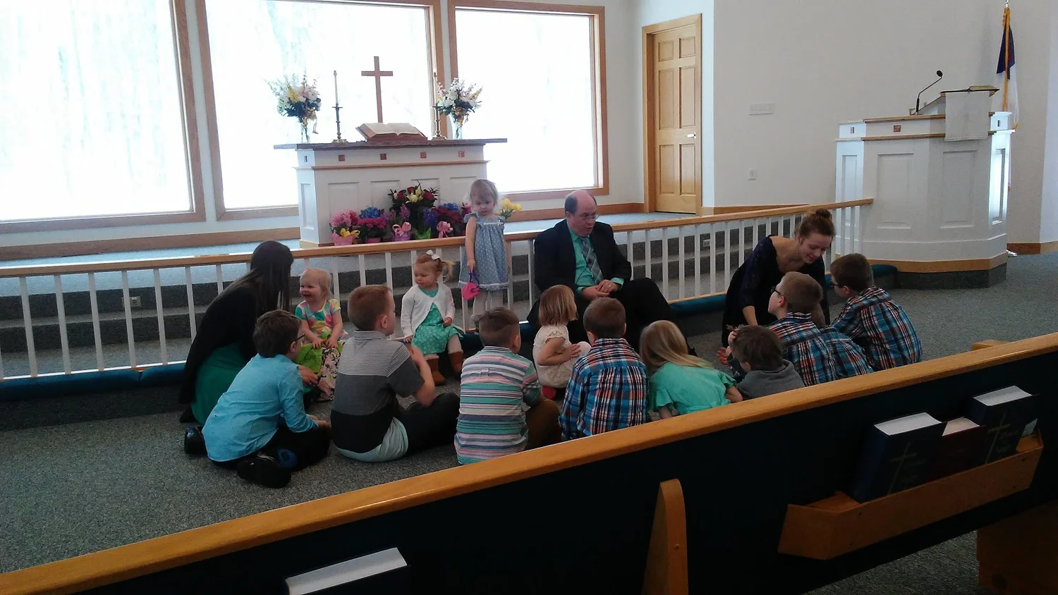 Children seated near the altar during Easter worship