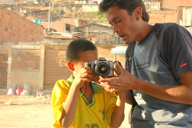 One of our volunteers teaching photography to children from deprived communities.
