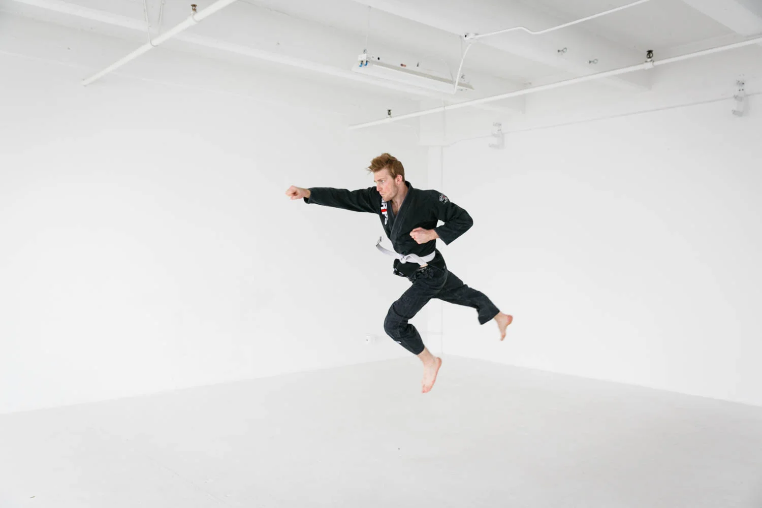 lost format derek danger cooper mma fighter studio portrait shoot jumping punch flying.jpg