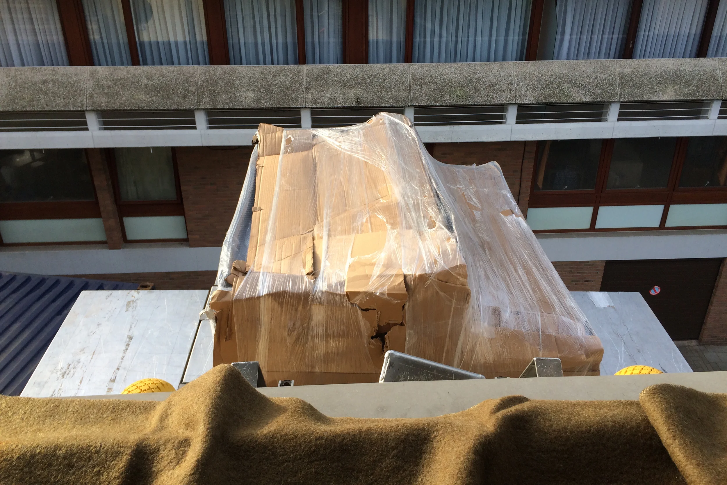 Noelle’s piano is delivered through the window of her new apartment. (Brussels, Belgium.)