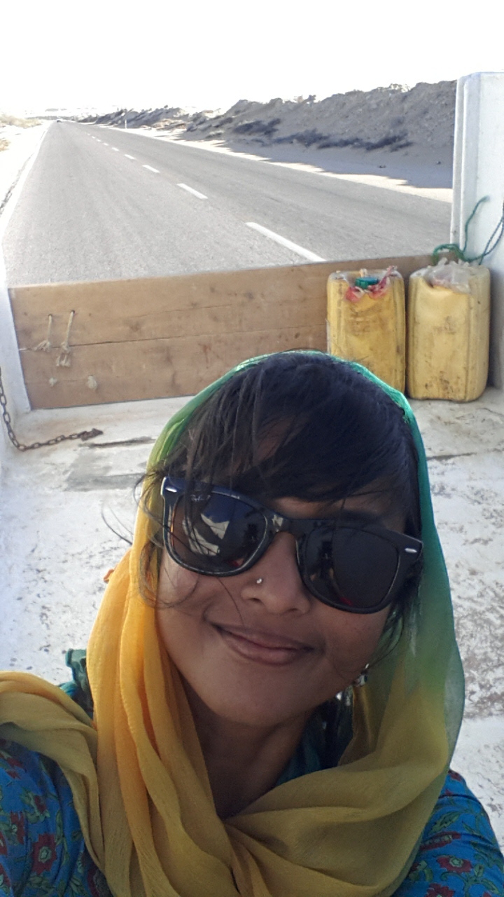 Adventurous Anusha hitchhiking in the back of a truck