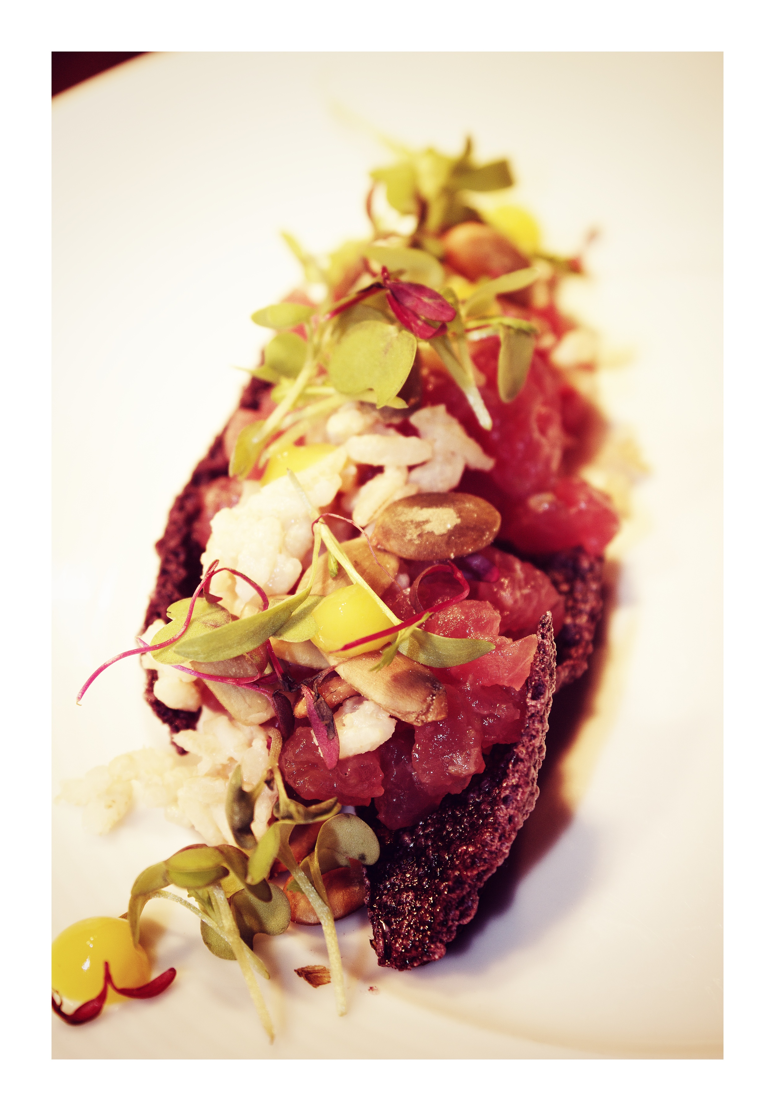 black forbidden rice crisp | bigeye tuna tartare | baby cabbage | yuzu kosho | chewy line nuts |