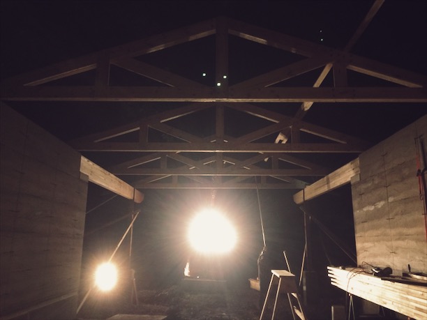  Site-built trusses being set with the excavator, at night no less.&nbsp; 
