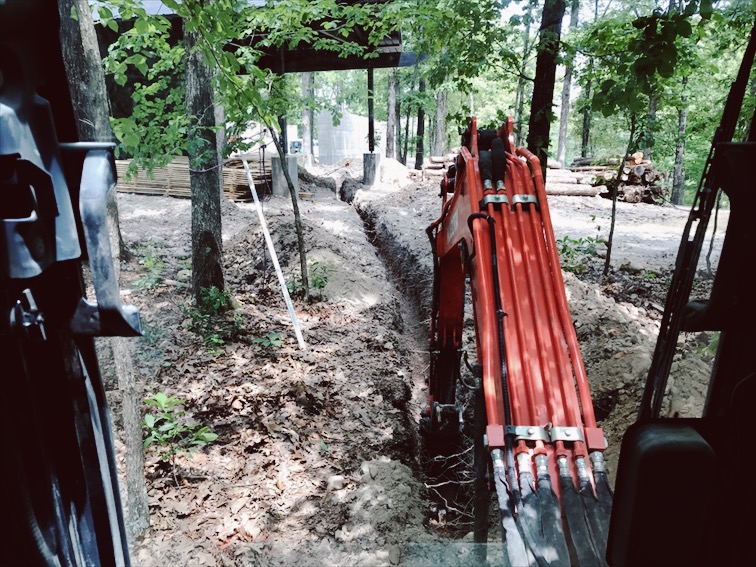  Me trenching for the sewer lines. Threading the needle through the garage columns.&nbsp; 