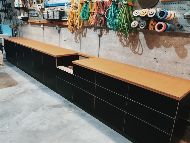  Here they are installed with an oiled MDF countertop. The cabinets are made from black concrete form-ply, a nod to the forms used to create the rammed earth walls.&nbsp; 