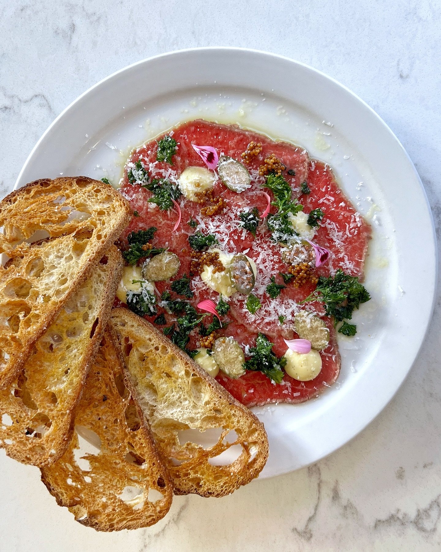 Dare you to order just one! &gt; 🥩 BEEF CARPACCIO 🥩&gt;&gt; thinly sliced rare beef, pecorino, fried parsley, caper berries, dijon aioli, pickled mustard seeds, sourdough crostini &gt; team favourite snack at The Canteen! See you for dinner! 

#can