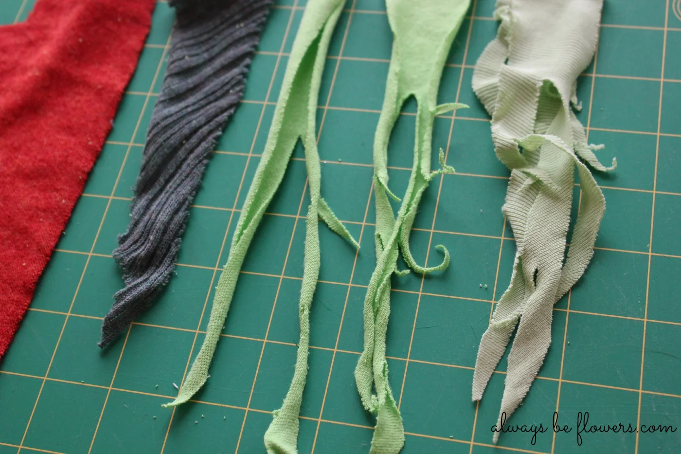 Cut into the pieces of green and pull on the strips to create textured curls.