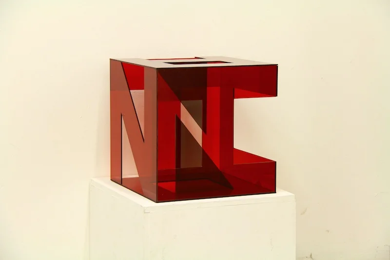 constructed from acrylic which allows the viewer to find multiple words upon different viewings, including hidden letter forms 