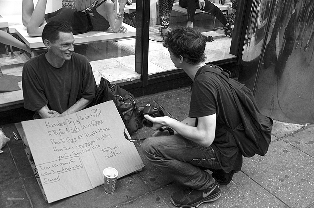 I have always been drawn to homeless people since I am always aware that any of us could be a day away from being there. In this instance I was out doing some street shooting with actor and great guy, Israel Broussard. I asked him if he had ever photographed homeless people and told him in doing so it's best to introduce yourself, have a conversation and ask them if they would mind if you took their picture. Oh, and always add something to the cup. In this instance, it was so amazing for me to witness their conversation where they both learned something from each other. And Israel got some great pictures.