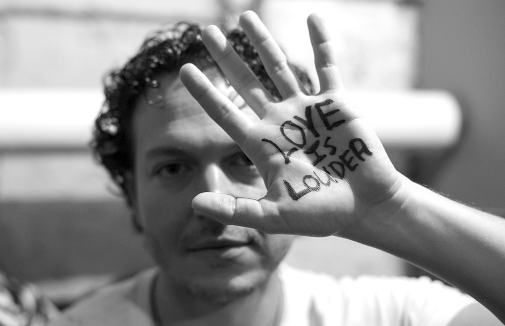 I was backstage with Jay Stolar shooting him while he was printing this sign on his hand prior to hitting the stage at the Mercury Lounge. He had recently aligned himself with the Love Is Louder movement. Check it out.