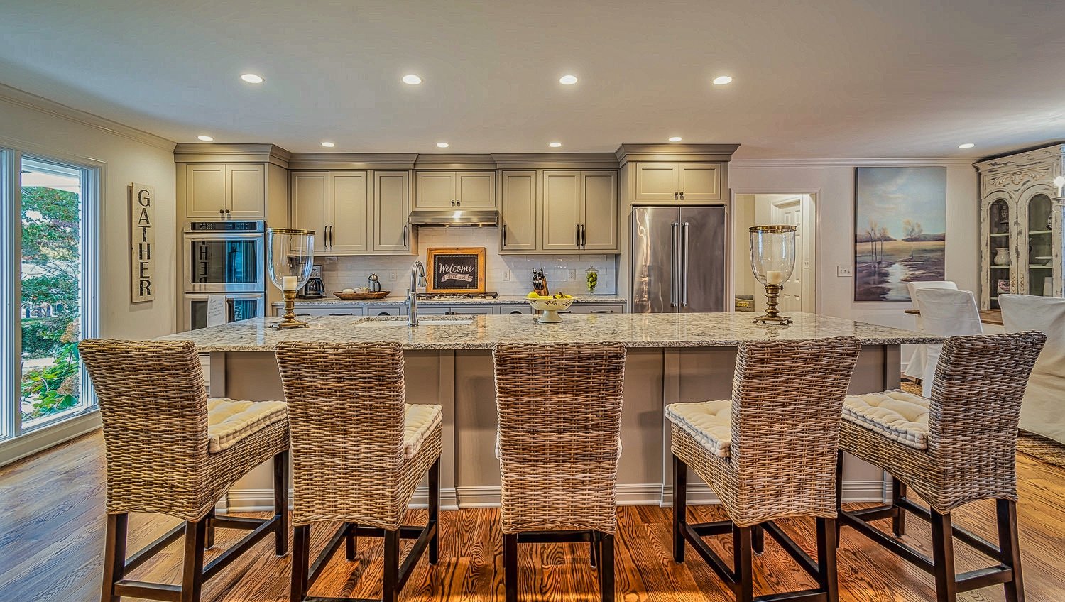 Wide home kitchen center island with four chairs