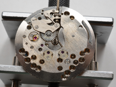 The cap jewels on the bottom of the movement as well as the bottom of the balance shock protection system and the keyless winding system can be seen here.