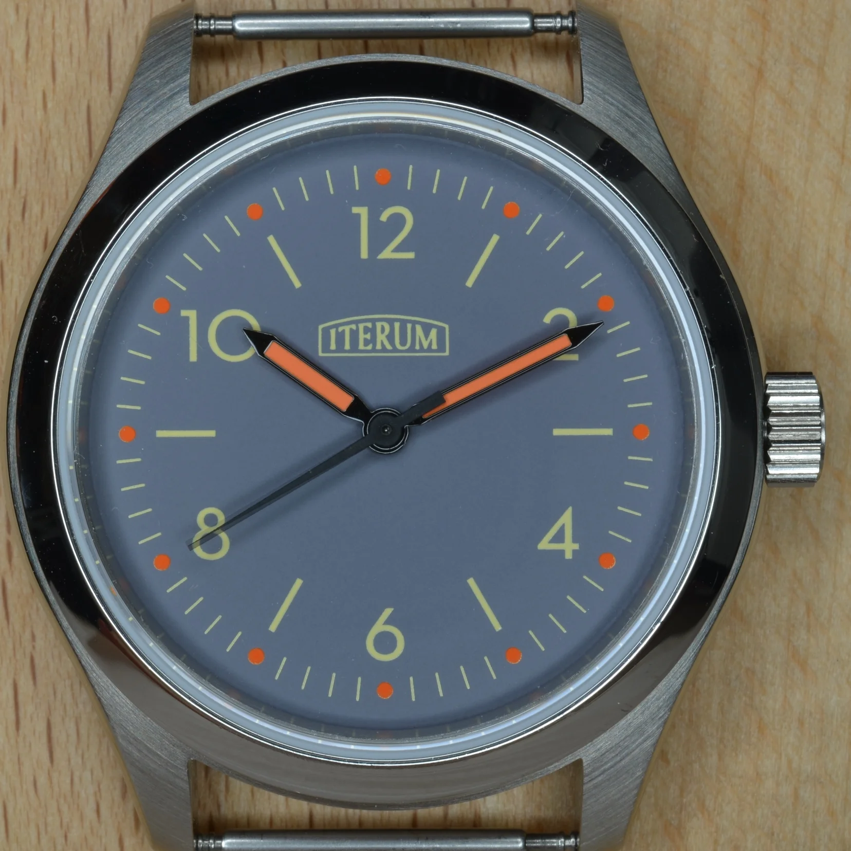 This dial has a blue-gray background and orange hour markers.
