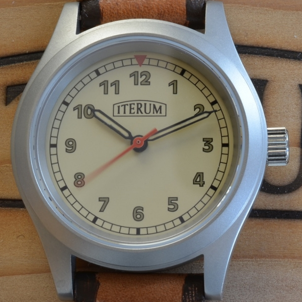 This dial has a beige background and&nbsp;railroad track minute markers.