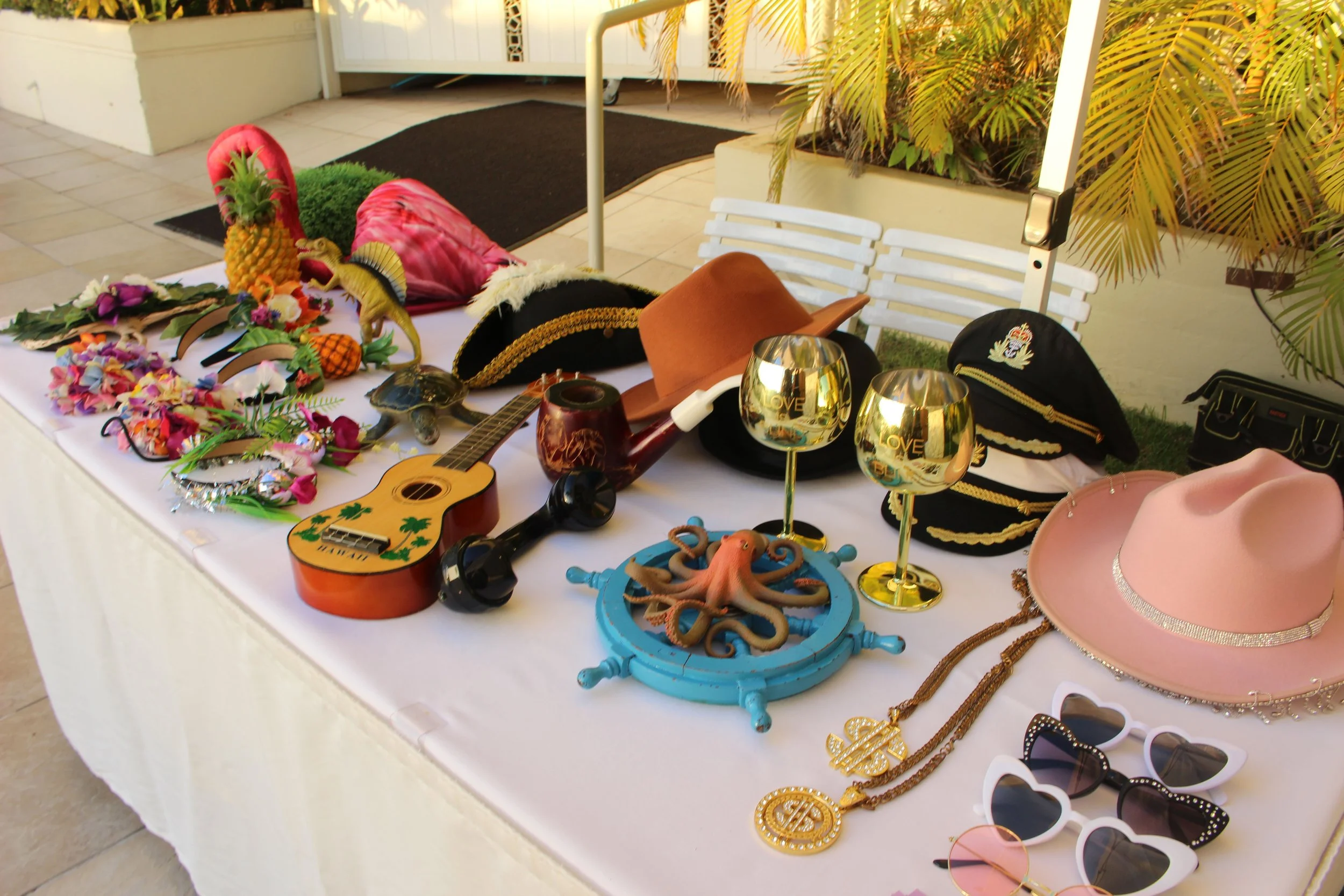 Table set up with vintage and aloha photo booth props