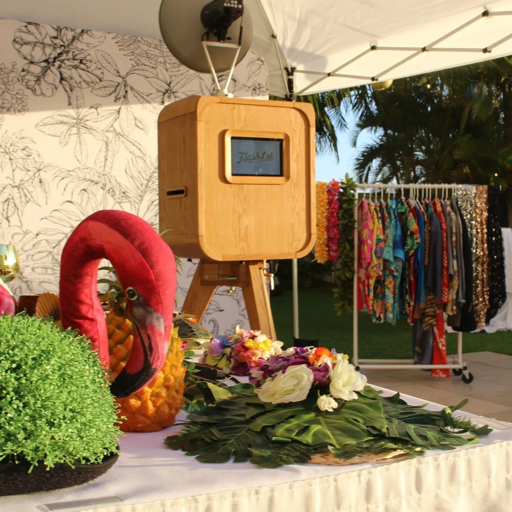 Open-air photo booth set up outdoors for a birthday party on Oahu