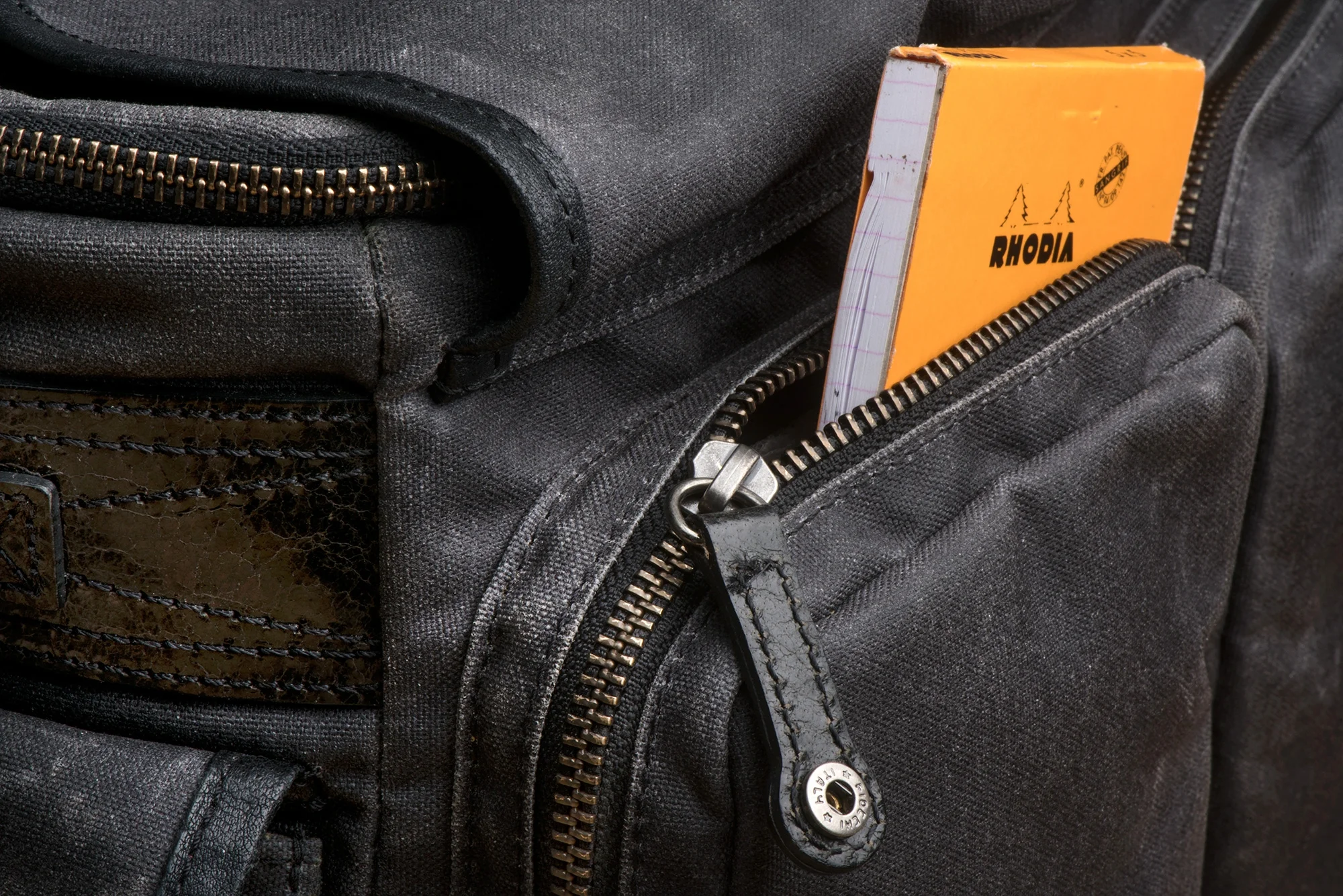 Dual zipper / pulls are outfitted on each of the large front pockets -- accessible from the top or bottom of the pocket. Each can also be snapped down securely to ensure the pocket doesn't get accidentally unzipped.