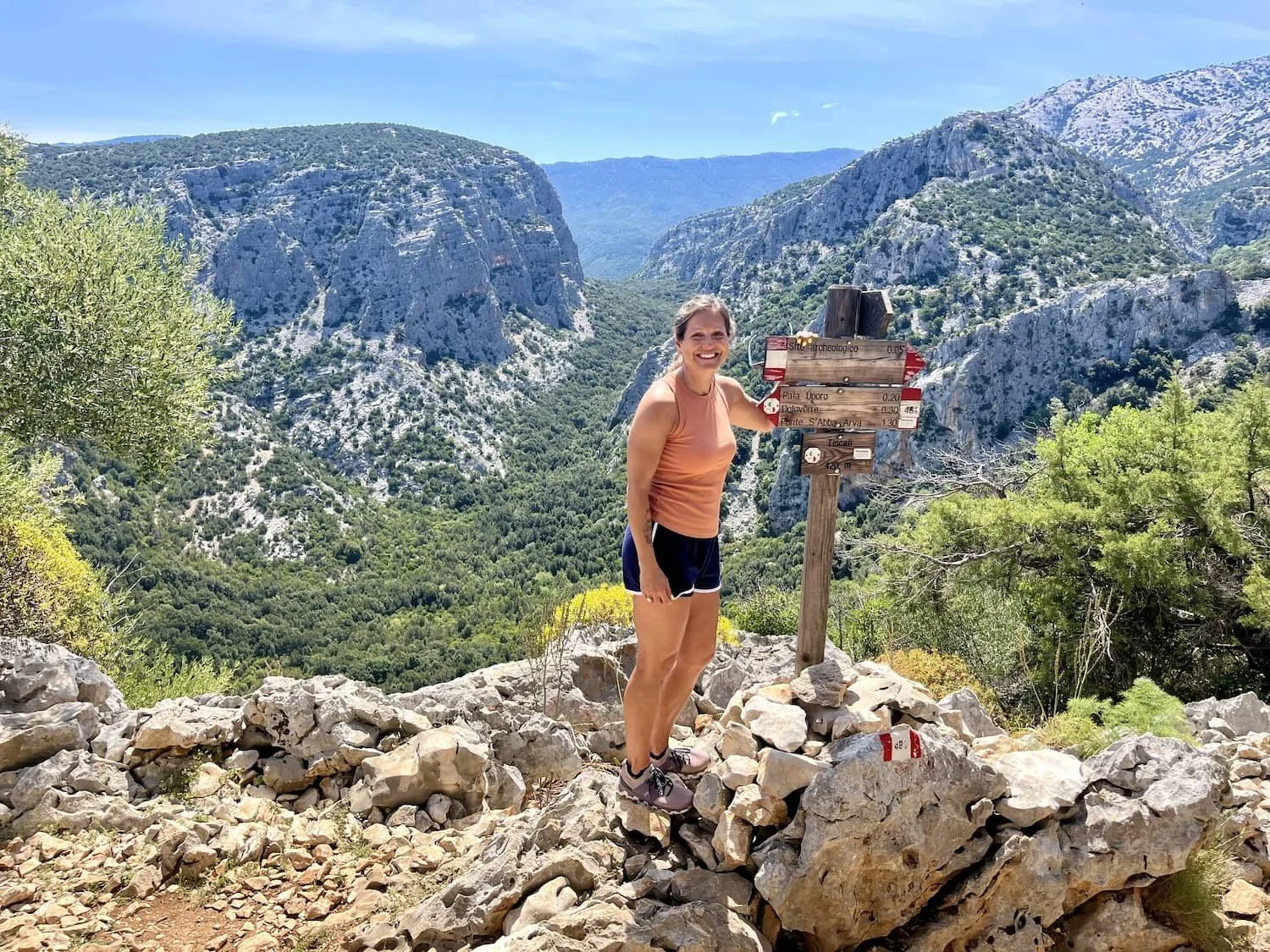 A woman named Jill Case standing on a rock with a sign.