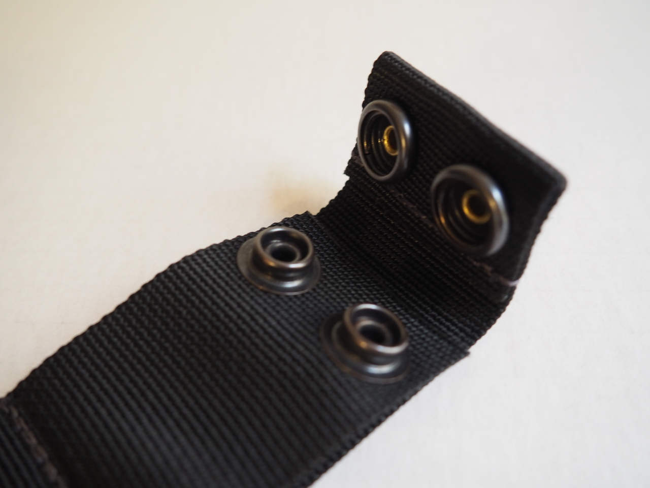 Cross strap connects to the main strap via a strong double snap closure