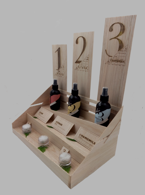 Planks showing numbers to intrigue audience from far way. Bottom to top: concentrated scent tester, labels, bottles, and planks