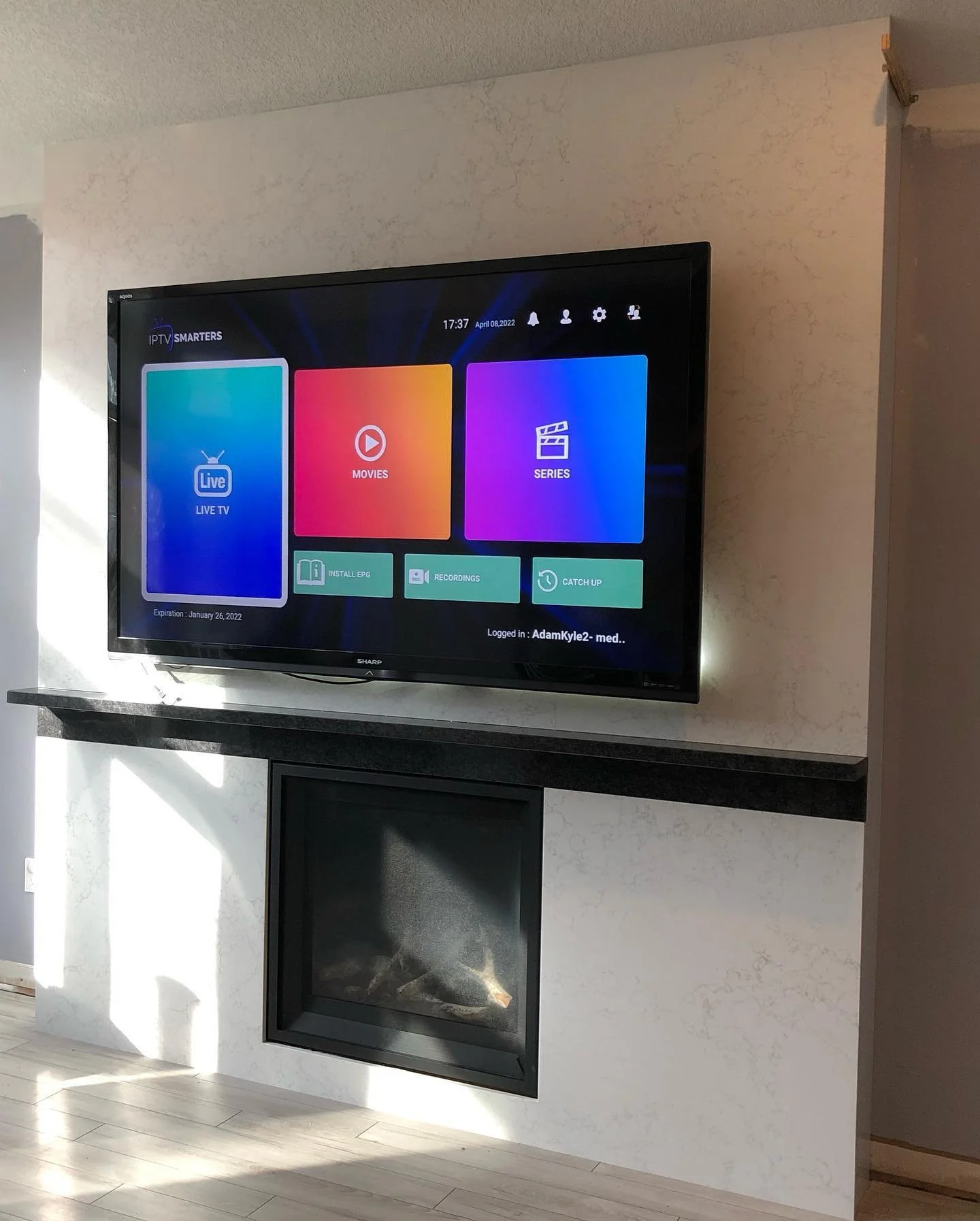 Full TV / Fireplace accent wall in LG Viatera Adagio Gold quartz and mantel in Steel Grey granite