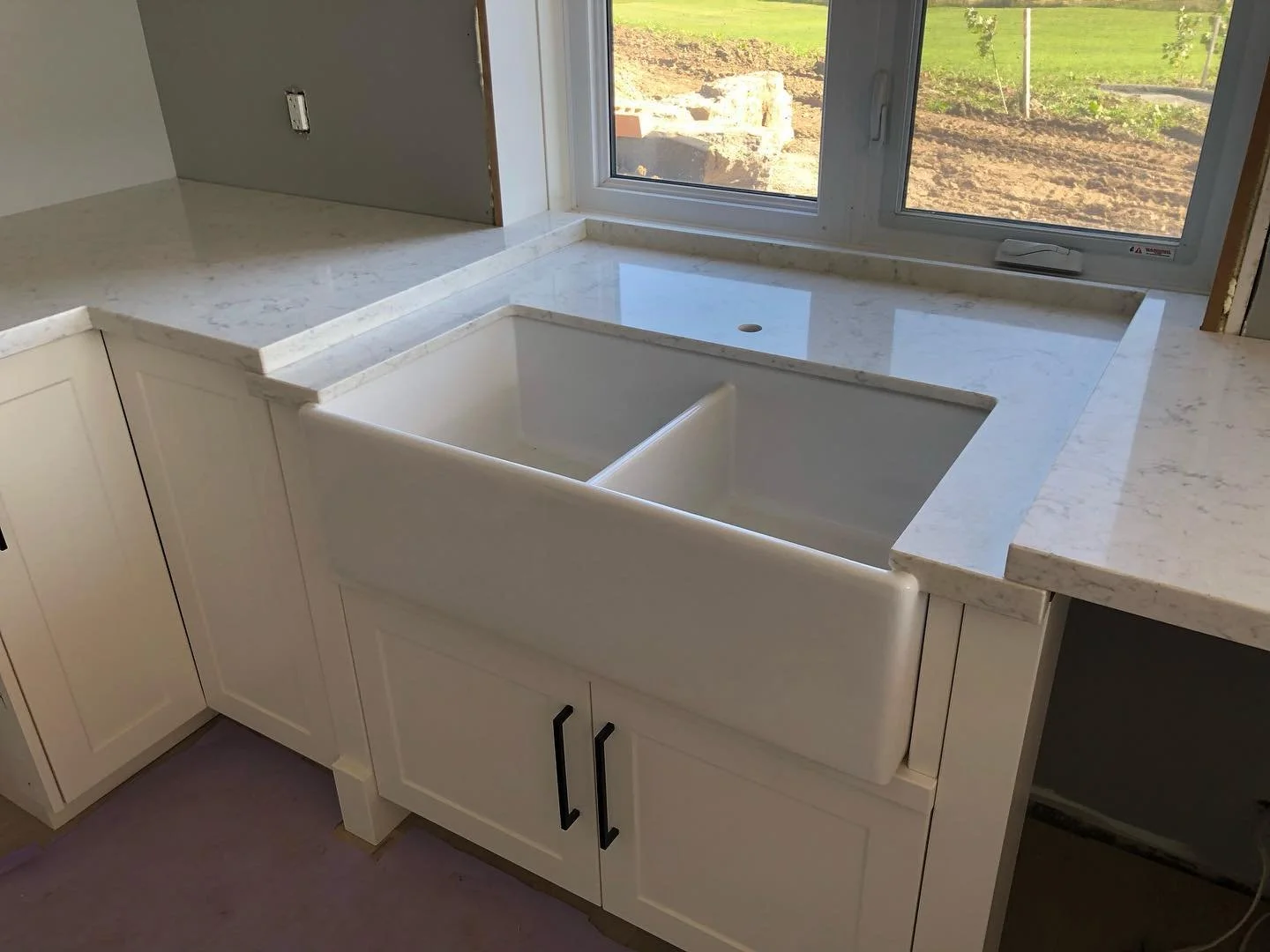 LG Viatera Minuet quartz countertops with custom built in farmers sink.
