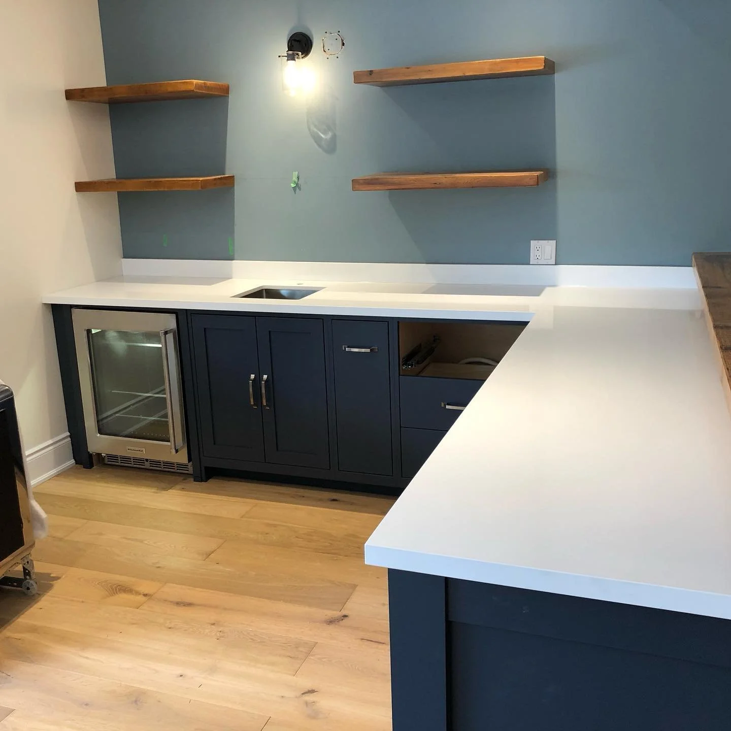 Royale Blanc Hanstone Quartz bar area and matching bathroom vanity countertop.